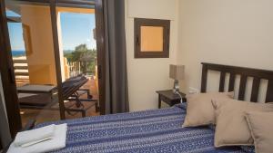 a bedroom with a bed with a view of the ocean at Coto Real Andros 201 in Manilva +19 photos