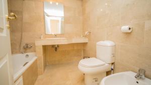 a bathroom with a toilet and a sink and a mirror at Coto Real Naxos 321 in Manilva +14 photos
