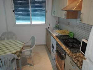 a kitchen with a table and a stove top oven at Le luxe du Lac 2 in Berges Du Lac
