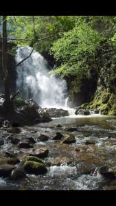 a stream of water with rocks and a waterfall at Eskolazaharra in Oronoz-Mugaire