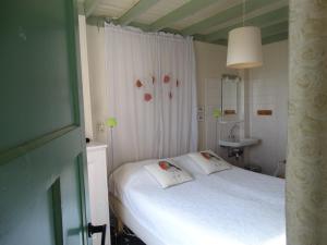a small bedroom with a white bed and a sink at De Erfdijk in Herpen