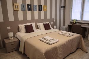 a bedroom with a bed with two towels on it at CHEZROMYK the K B&B in Milan