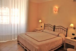Postel nebo postele na pokoji v ubytování Hotel Relais Modica