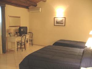 Postel nebo postele na pokoji v ubytování Hotel Relais Modica
