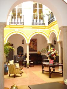 a lobby with an archway and a table and chairs at Hotel Abanico in Seville