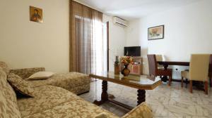 a living room with a couch and a table at Apartment Glomazic in Budva