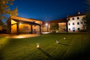 a house with two lights in a yard at night at Agriturismo Borgo Tecla in Rosà