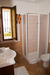 a bathroom with a shower and a sink and a toilet at Ambrosia casa vacanza " Giada " in Orosei +20 photos