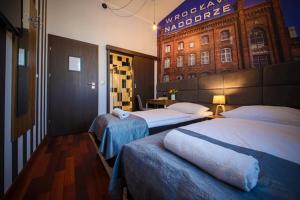 a hotel room with two beds and a building at Boogie ApartHouse Old Town in Wrocław