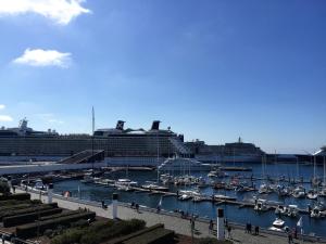 a group of boats docked in a harbor with a cruise ship at Solmar Alojamentos in Ponta Delgada