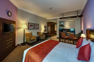 a hotel room with a bed and a living room at J5 RIMAL Hotel Apartments in Dubai