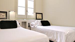 Posteľ alebo postele v izbe v ubytovaní BizFlats Eixample Apartments