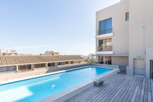 a swimming pool on the roof of a building at The Odyssee 409 in Cape Town