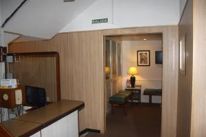 a hotel room with a hallway with a desk and a room at Hotel Ideal in Montevideo