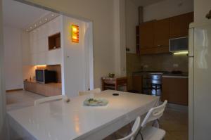 a kitchen with a white table and white chairs at Casa di Franca in Camaiore