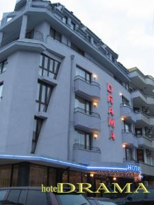 a hotel building with a sign on the side of it at Hotel Drama Burgas in Burgas