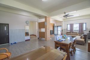 a living room with a table and a dining room at Homelike Homestay in Huxi