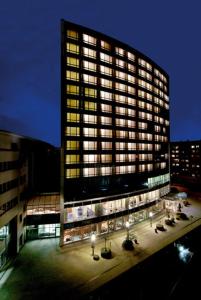 a large building with many windows at night at Lindner Hotel Cottbus in Cottbus