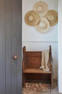 a room with a wooden bench with hats on the wall at Lulworth Lodge in Lulworth Cove