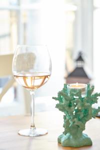 a glass of wine and a candle on a table at Lulworth Lodge in Lulworth Cove
