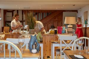 a group of people standing in a kitchen with a table at Lulworth Lodge in Lulworth Cove