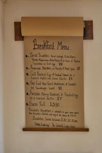 a handwritten menu on a cardboard box on a wall at Lulworth Lodge in Lulworth Cove