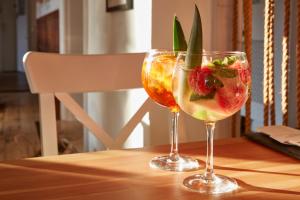 two wine glasses with fruit in them on a table at Lulworth Lodge in Lulworth Cove