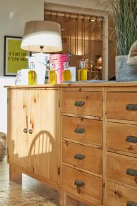 a wooden dresser with a lamp on top of it at Lulworth Lodge in Lulworth Cove