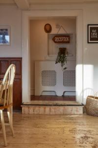 a living room with a table and a chair at Lulworth Lodge in Lulworth Cove