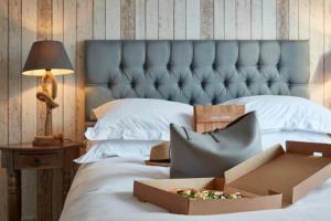 a bed with a blue headboard and a box on it at Lulworth Lodge in Lulworth Cove