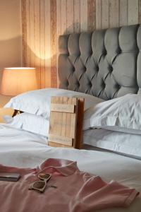 a pair of glasses sitting on top of a bed at Lulworth Lodge in Lulworth Cove