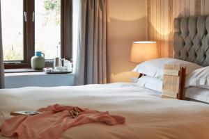 a bedroom with a bed with a dress on it at Lulworth Lodge in Lulworth Cove