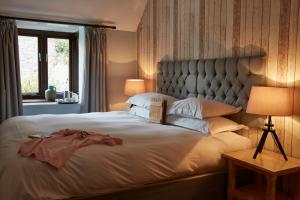a bedroom with a large bed with a large headboard at Lulworth Lodge in Lulworth Cove