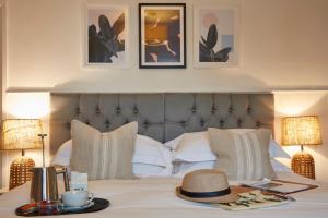 a bedroom with a bed with a hat on it at Lulworth Lodge in Lulworth Cove