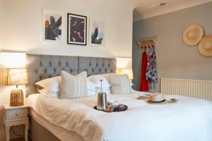 a bed with a tray of food on top of it at Lulworth Lodge in Lulworth Cove