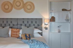 a bedroom with a bed with hats on the wall at Lulworth Lodge in Lulworth Cove