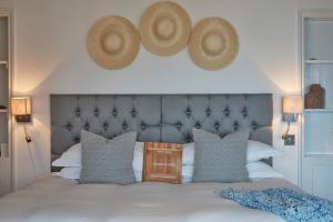 a bedroom with a bed with two hats on the wall at Lulworth Lodge in Lulworth Cove