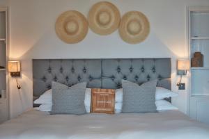 a bedroom with a bed with two hats on the wall at Lulworth Lodge in Lulworth Cove