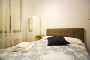 a bedroom with a bed with towels on it at Via Guelfa Apartment in Florence