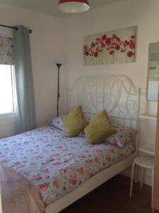 a bedroom with a bed with a floral bedspread at For-Get-Me-Not Chalet semi detached in Bridlington