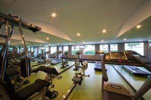 a gym with a row of treadmills and cardio machines at M'AR De AR Aqueduto in Évora