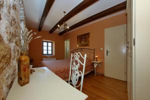 a bedroom with a bed and a table at Olive's Hug in Poljana +19 photos