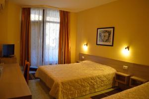 a hotel room with two beds and a window at Hotel Drama Burgas in Burgas +14 photos