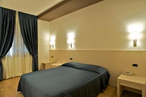 Postelja oz. postelje v sobi nastanitve Sam Hotel