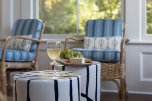 un verre de vin assis sur une table avec deux chaises dans l'établissement Margin Street Inn, à Westerly