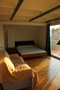 a bedroom with two beds and a large window at Acropolis view penthouse in Athens