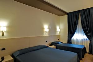 Postelja oz. postelje v sobi nastanitve Sam Hotel