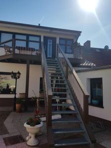 a house with a staircase in front of a house at Gemütliche Idylle am Seddinsee in Gosen