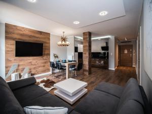 a living room with a couch and a table at Apartamenty Bawaria in Szklarska Poręba