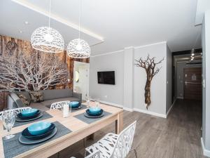 a dining room and living room with a table and chairs at Apartamenty Bawaria in Szklarska Poręba